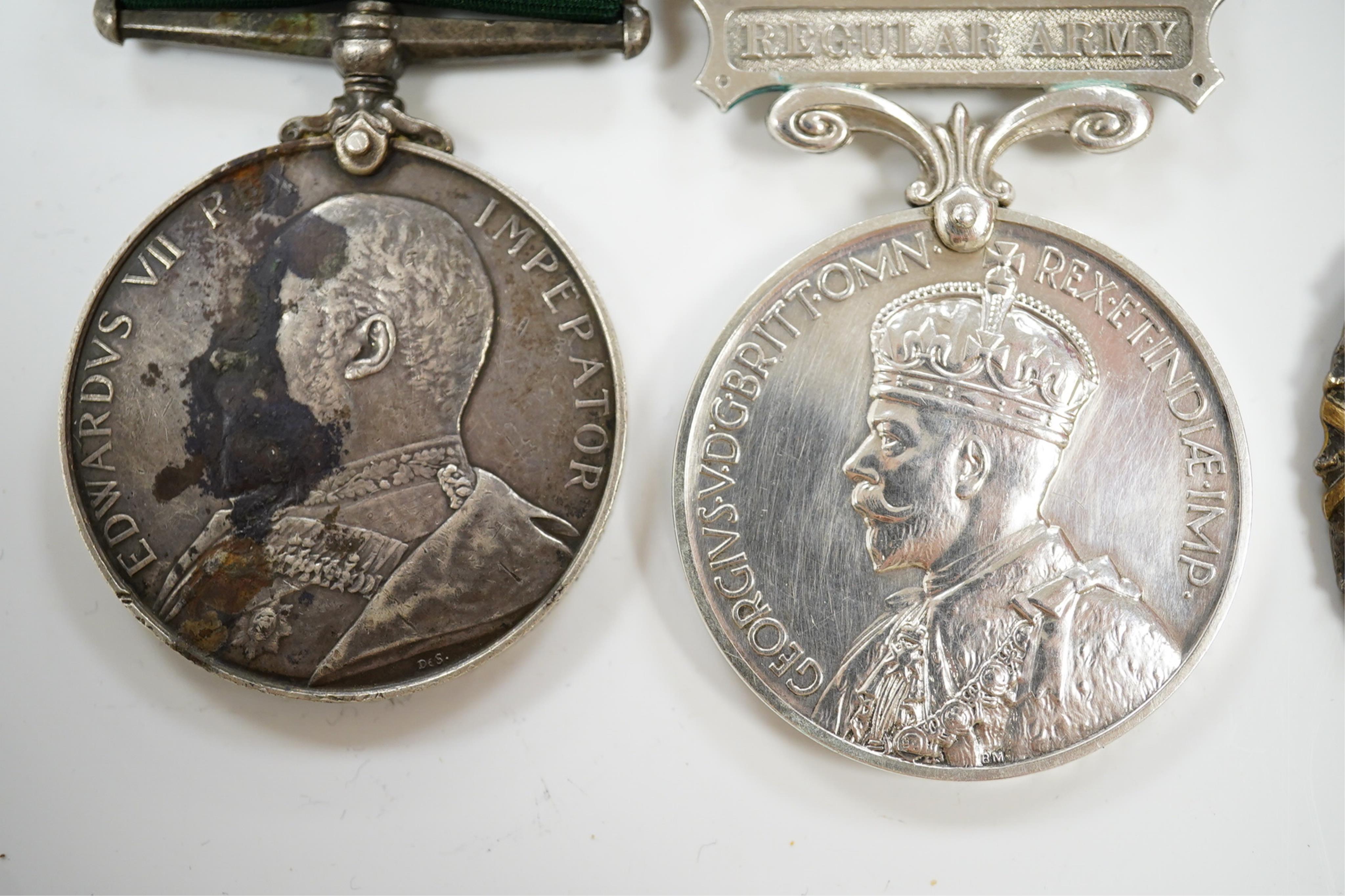 Four assorted service medals; Volunteer Officer's Decoration, hallmarked for 1892; EdVII Volunteer Long Service Medal to 3648 Pte W.Austin I/V B:Lanc:Fus; GV Imperial Service Medal to Frederick Allan Heselwood & Gv Regul